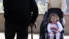 FILE - An elderly man (L) uses a cane to support his walk as he approches a child being pushed in a stroller, in Rome, Italy, April 27, 2007. Life expectancy worldwide rose by five years between 2000 and 2015, according to the World Health Organization.