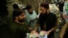 FILE - Mohammad Yaqoob Sheikh, right, nominated candidate of the Milli Muslim League, distributes handbills to residents during an election campaign for the National Assembly NA-120 constituency in Lahore, Pakistan, Sept. 10, 2017.