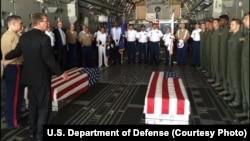 U.S. Defense Secretary Ash Carter, second left, with U.S. military members after they loaded the casket of what could be the remains of one to two crew members from a World War Two crash, in a C-17 aircraft, at Palam airport, in New Delhi, India, April 13
