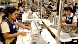 FILE: Cambodian garment workers sew clothes in a factory in Phnom Penh, Cambodia, Aug. 4, 2007.