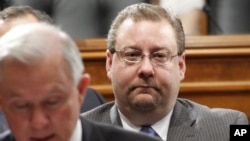 FILE - Brian Benczkowski, then the Republican staff director of the Senate Judiciary Committee, sits behind the committee's ranking Republican, then-Sen. Jeff Sessions, R-Ala., during a committee hearing on Capitol Hill, June 18, 2009.
