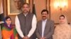 In this photo released by the Press Information Department, Pakistani Nobel Peace Prize winner Malala Yousafzai, left, and her parents pose for a photograph with Shahid Khaqan Abbasi, second from left, Prime Minister of Pakistan in Islamabad, Pakistan, March 29, 2018.