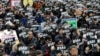 FILE - Demonstrators supporting the MeToo movement in black stage a rally to mark the International Women's Day in Seoul, South Korea, March 8, 2018. 