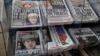 Newspapers fronted with photos of British Prime Minister Theresa May and others are displayed at a shop in Westminster in London, June 10, 2017. May has been criticized as too detached at times.