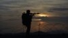 FILE - A Pakistani border security guard stands alert at Pakistan-Afghanistan border post, Chaman in Pakistan, May 5, 2017. The top American general in Afghanistan says Pakistan maintains ties with the Haqqani terrorist network.