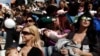 FILE - Women breastfeed babies during a mass event in Athens, Nov. 2, 2014.