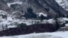Earth from a landslide covers an area in Liangshui Village, Zhaotong City, Yunnan province, China, in this screen grab from social media video released Jan. 22, 2024. 