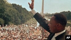 Martin Luther King Jr. acknowledges the crowd at the Lincoln Memorial for his "I Have a Dream" speech during the March on Washington, August 28, 1963.