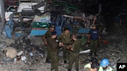 Pakistani security personnel visit the site of a blast in Lahore, Pakistan, Aug. 7, 2017.