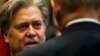 U.S. President Donald Trump's chief strategist Steve Bannon speaks with Homeland Security Secretary John Kelly during Trump's meeting with cyber security experts in the Roosevelt Room of the White House, Jan. 31, 2017. 