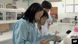 FILE - Women scientists are seen working in research lab in Jakarta, Indonesia.