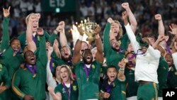 South African captain Siya Kolisi holds the Webb Ellis Cup aloft after South Africa defeated England to win the Rugby World Cup final at International Yokohama Stadium in Yokohama, Japan, Nov. 2, 2019.