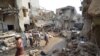 FILE - People gather at the site of a Saudi-led air strike in the Red Sea port city of Hodeidah, Yemen, Sept. 22, 2016. 