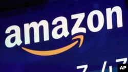 FILE - In this July 27, 2018 file photo, the logo for Amazon is displayed on a screen at the Nasdaq MarketSite. 