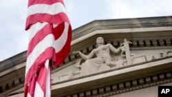 FILE - The front facade of the Robert F. Kennedy Department of Justice Building is seen in Washington, in a June 19, 2015, photo.