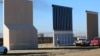 FILE - Three of U.S. President Donald Trump's eight border wall prototypes are shown near completion along U.S.- Mexico border in San Diego, California, Oct. 23, 2017. 