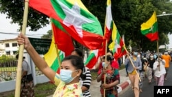 Military supporters wave Myanmar national flags during a protest to demand an inquiry to investigate the Union Election Commission (UEC) in Yangon on January 29, 2021, as fears swirl about a possible coup by the military over electoral fraud…