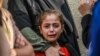 A girl cries as she and her relatives mourn the death of loved ones in Deir el-Balah on June 28, 2024, following Israeli bombardments in the Gaza Strip.