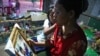 Seth Sreymom looks at the photo of her daughters on October 13, 2019. They died of drowning. (Kann Vicheika/VOA Khmer)