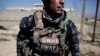 A member of the federal police smokes a cigarette during a break in fighting against Islamic State militants, in Hamam al-Alil, Iraq, Feb. 19, 2017. 