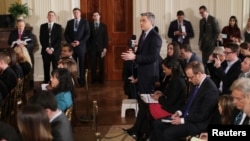 FILE - CNN reporter Jim Acosta asks a question during a news conference held by U.S. President Donald Trump at the White House in Washington, Feb. 16, 2017.