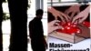 FILE - A man walks by a poster of the Swiss People's Party (SVP/UDC) argueing against the automatic right to citizenship, even for children born in Switzerland to foreign parents on Sept. 9, 2004.