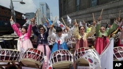 Christian believers beat drums during a protest opposing the homosexuality and same-sex marriage near the venue where thousands of supporters participating to celebrate the 16th Korea Queer Festival in Seoul, South Korea, Sunday, June 28, 2015. The…
