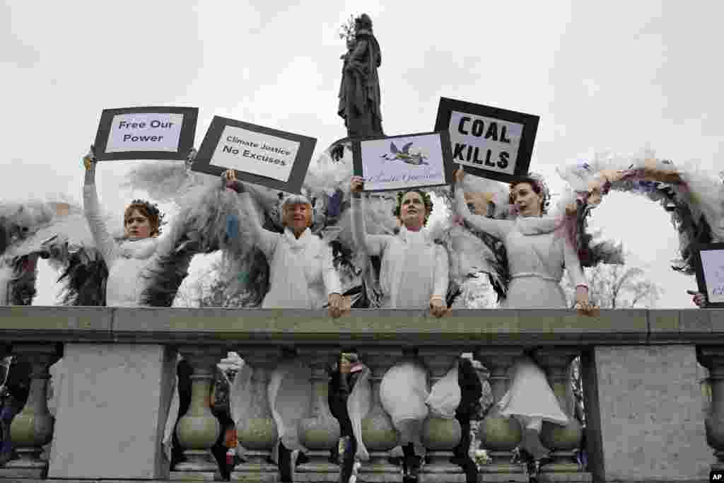 Des femmes vêtues en anges posent à la place de la République, à Paris, dans le cadre d'un rassemblement symbolique et pacifique appelée par l'ONG Avaaz "Paris se prépare pour le climat", 29 novembre 2015. 