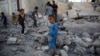 FILE - Children play amid the rubble of a house destroyed by a Saudi-led airstrike in Sana'a, Yemen, Sept. 8, 2015. 