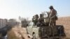 FILE - In this Dec. 22, 2015 photo, Afghan security forces patrol in Nad Ali district of Helmand province, Afghanistan. Late on Sept. 23, 2017, Taliban insurgents ambushed and killed the district police chief and his three bodyguards. 