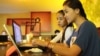 University students from the Royal University of Phnom Penh browsing the Internet at a coffee shop along Phnom Penh's Russian Federation Boulevard, June 13, 2014. (Photo: Suy Heimkhemra/VOA Khmer)