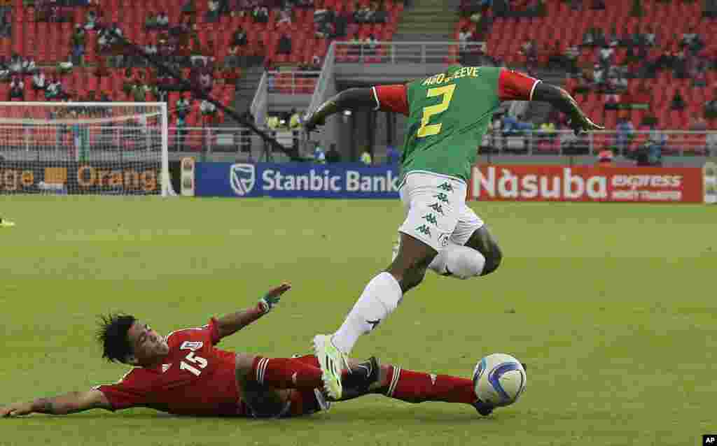 Ivan Edu Salvador de la Guinée équatoriale, à gauche, tente de prendre la balle à Steeve Yago du Burkina Faso, à droite, lors du match de football de la Coupe d'Afrique des Nations Groupe A à Bata, en Guinée équatoriale, mercredi 21 janvier 2015.