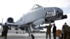 FILE - U.S. military forces stand beside an A-10C Thunderbolt II ground attack aircraft at Kandahar Airfield, Afghanistan, Jan. 23, 2018.