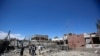 FILE - Yemeni people inspect the damage after an airstrike by Saudi-led coalition in Sana'a, Yemen, Saturday, Feb. 27, 2016. 