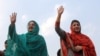 FILE - Kulsoom Nawaz (L), wife, and Maryam Nawaz (R), daughter former Pakistani prime minister Nawaz Sharif, wave to supporters at a campaign rally in Lahore, Pakistan, on May 4, 2013. Kulsoom Nawaz won her husband's parliamentary seat in a by-election Sunday.