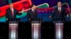 Presidential candidate Donald Trump (L) responds to criticism from former Governor Jeb Bush (R) as Senator Ted Cruz (C) looks on during the Republican presidential debate in Las Vegas.