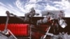 Potongan gambar dari sebuah video yang menunjukkan seorang astronaut China tampak beraktivitas mengitari stasiun antariksa Tiangong pada 9 Februari 2023. (Foto: Liu Fang/Xinhua via AP)