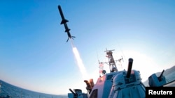 A missile is fired from a naval vessel during the test-firing of a new type of anti-ship cruise missile to be equipped at Korean People's Army (KPA) naval units in this undated photo released by North Korea's Korean Central News Agency (KCNA) in Pyongyang