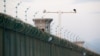 Security cameras are installed above the perimeter fence of what is officially known as a vocational skills education center in Dabancheng, in Xinjiang Uighur Autonomous Region, China, Sept. 4, 2018. 