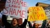 Women hold posters bearing messages against the Australian Labor Party during a rally in support of asylum seekers outside an ALP meeting in Sydney, Australia, July 22, 2013.