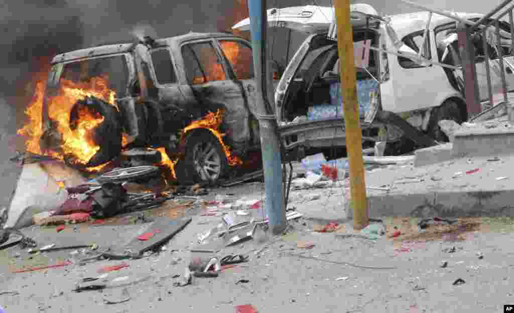 Des voitures brûlent à l'extérieur du centre commercial de Midnimo, après un attentat, à Mogadiscio, Somalie, le 30 juillet 2017.