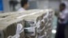FILE - Stacks of Myanmar kyat are seen on the counter before a client collects them, at a bank in Yangon, Myanmar October 19, 2015.