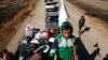 A displaced Iraqi child holds a white flag as he and his family flee during a battle with Islamic State militants in Kokjali village near Mosul, Iraq, Nov. 3, 2016. 
