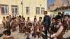 FILE - Iranian and Afghan boys play outside at the Be'sat school in Kerman, Iran, Oct. 23, 2016. 
