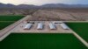 FILE - Bales of hay are stored under shelters at Al Dahra Farms, Oct. 17, 2023, in the McMullen Valley in Wenden, Arizona. The state's attorney general said she is suing an alfalfa farm in western Arizona, Fondomonte, for its groundwater usage. 