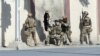 FILE - Afghan security personnel take positions near the Shamshad Television station after a deadly attack in Kabul, Afghanistan, Nov. 7, 2017, for which the Islamic State group claimed responsibility.