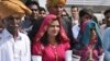 Krishna Kumari, center, newly elected Senator of the Pakistani Hindu Community, arrives at the Parliament with her family members in Islamabad, March 12, 2018. 