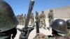 FILE - Afghan soldiers train with their weapons at the Kabul Military Training Center on the outskirts of the Afghan capital.