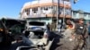 Afghan security forces inspect the site of a suicide attack in Jalalabad, Afghanistan, March 7, 2018. 