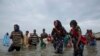 In this July 26, 2019 photo, Ethiopian migrants disembark from a boat onto the shores of Ras al-Ara, Lahj, Yemen. Funded by the European Union, Ethiopia has cracked down on migrant smugglers and intensified border controls. Arrests of known brokers…